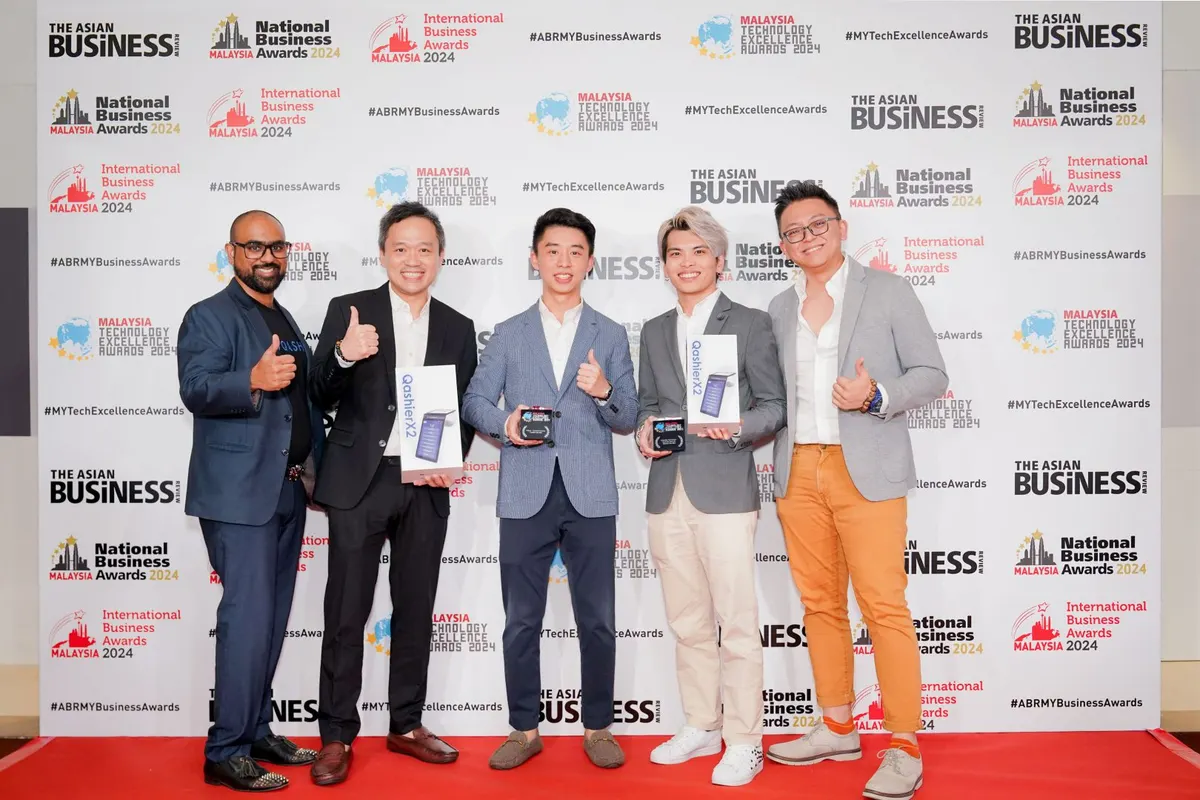 The Qashier Malaysia team holding QashierX2 and their Malaysia Technology Excellence Awards 2024 trophies